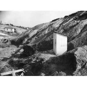  An Outhouse in an Area That Is Plagued with Soil Erosion 
