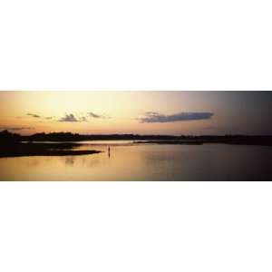  Silhouette of a Person Fishing in a Lake at Dusk, Rye 