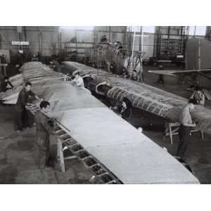  Workers on the Wing of an Airplane in the Caproni Factory 