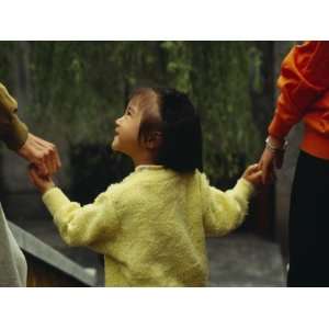 China, Shanghai, Little Girl Holding Parents Hands Photographic 