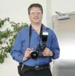 John Uske with his Olympus C 770 UZ camera working as a photographer 