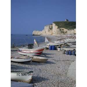 Small Boats and People on the Beach with Cliffs in the Background 