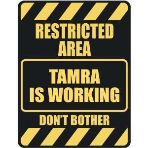   RESTRICTED AREA TAMRA IS WORKING  PARKING SIGN