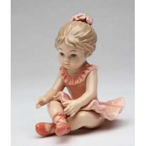   in Peach Dress Sitting Down with Crossed Legs Figurine