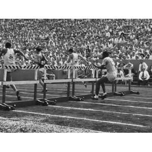  Athletes Running the 110 Meter Hurdles During the U.S 